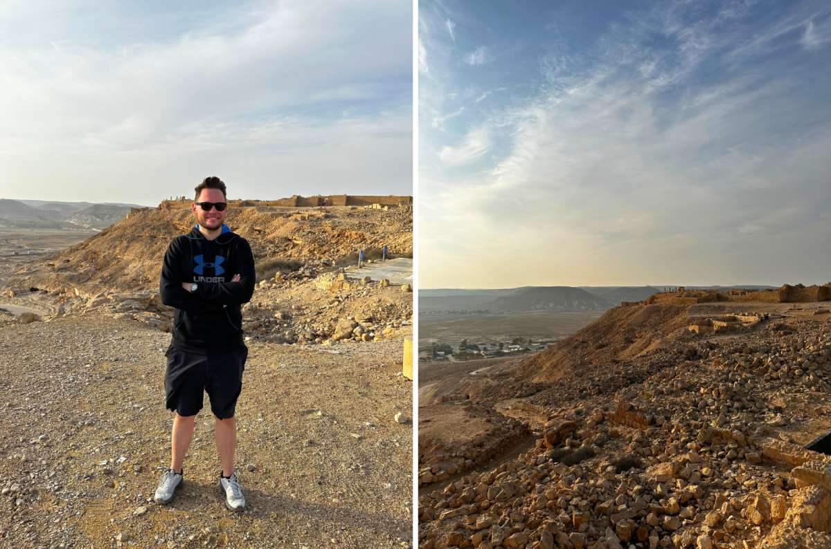 Views from Avdat National Park in the Negev Desert, Israel, with a tourist standing among rocky ruins, photo by Next Level of Travel