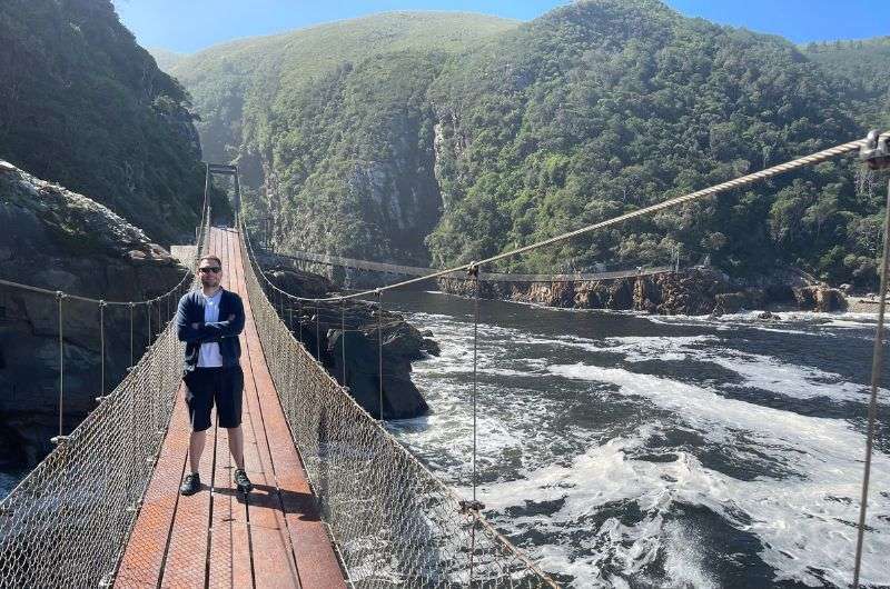 A tourist in Storm River Mouth in Tsitsikamma National Park, South Africa  