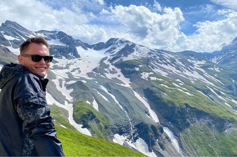 A tourist at a viewpoint of the Austrian Alps