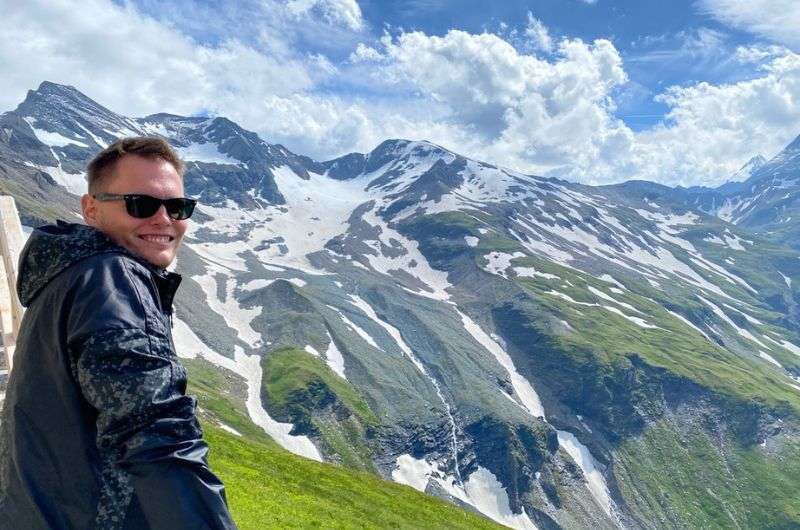 Tourist enjoying a hike in the Austrian Alps, photo by Next Level of Travel
