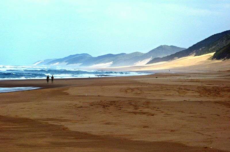 A couple walking at Sodwana Bay, South Africa