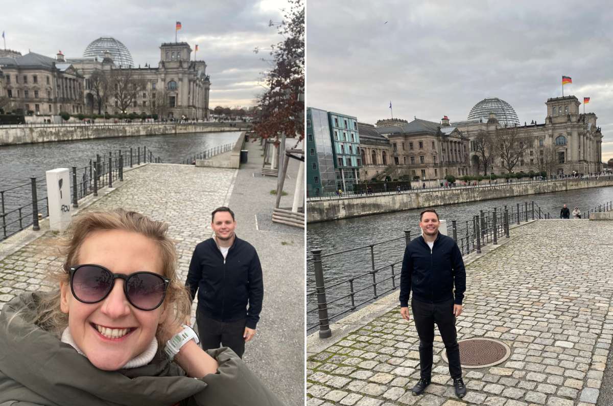 Couple taking picture along the Spree River in Berlin, Germany with the Reichstag building in the background, photo by Next Level of Travel