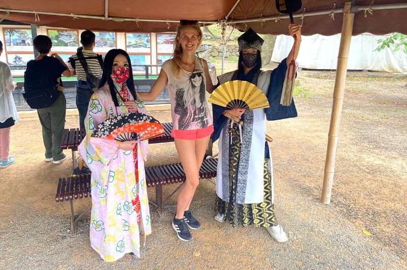 Taking a photo with costumed ladies in the garden of Matsumoto Castle, Nagano day trip, Japan