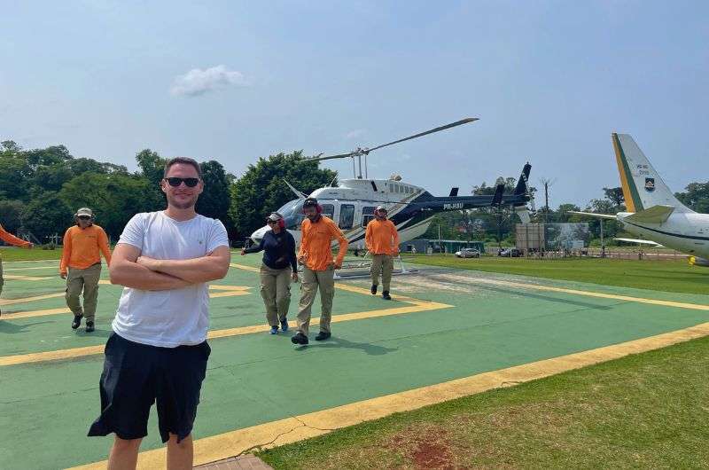 Taking pictures infront of a helicopter in Argentina, photo by Next Level of Travel