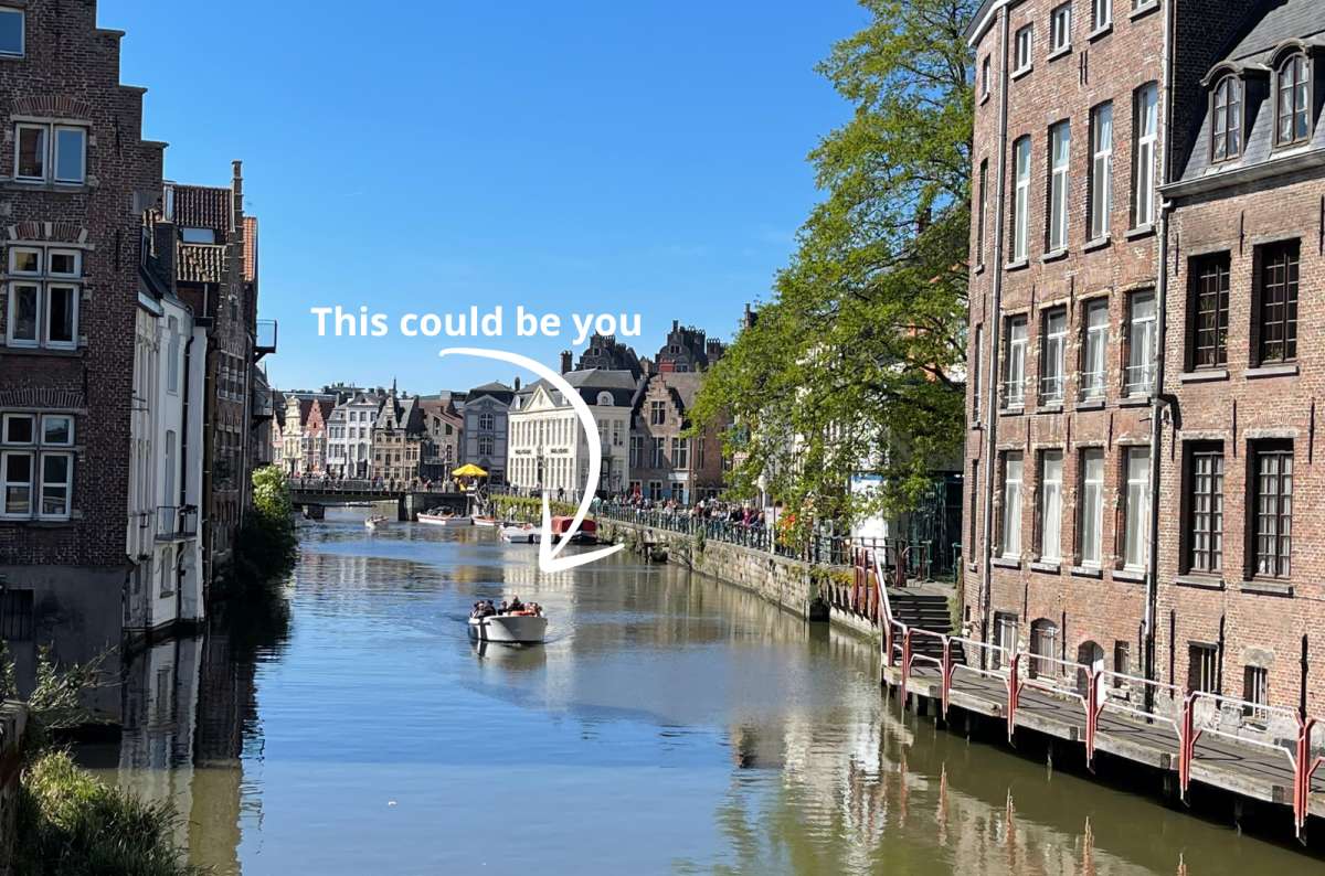 a photo of the Ghent canal with a boat tour in the center; Ghent, Belgium, photo by Next Level of Travel