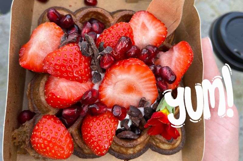 Eating waffles in Bruges in Belgium by Next Level of Travel