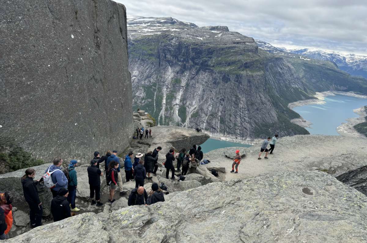 Tourists standing in line waiting for the famous Trulltunga viewpoint photo op, Norway, photo by Next Level of Travel