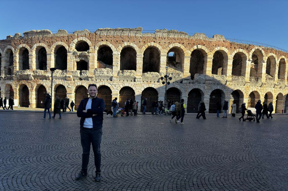 Author standing in front of the Verona Arena during a day trip from Padua, Italy, photo by Next Level of Travel 