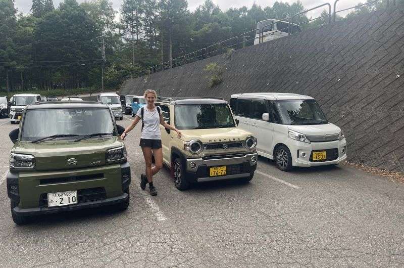 female tourist standing on the road between three cars in Nagano, Tagakushi Kojo, Japan, Photo by Next level of travel