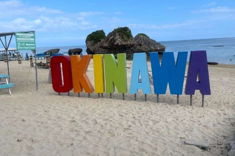 wooden sign on the beach - Okinawa, Japan, photo by Next level of Travel