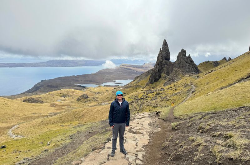 traveler posing on the Old Man of Storr hike, Scotland, photo by Next level of travel