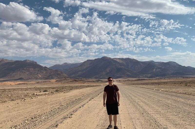 tourist in front of the Mt. Brandberg and Königstein, Namibia, photo by Next level of travel