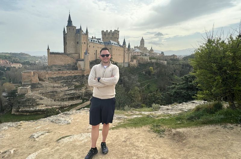 Man in front of the Alcázar of Segovia, Spain, photo by Next level of travel