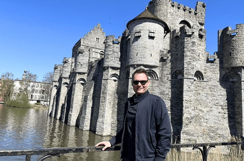 Tourist in front of the Gravensteen Castle, Ghent, Belgium, photo by Next level of travel