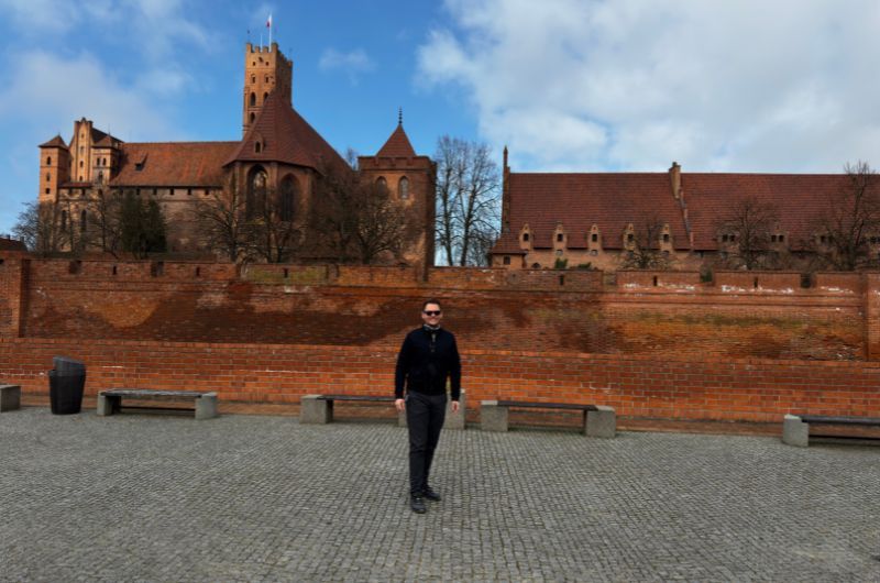 tourist in front of the Malbork Castle, Poland