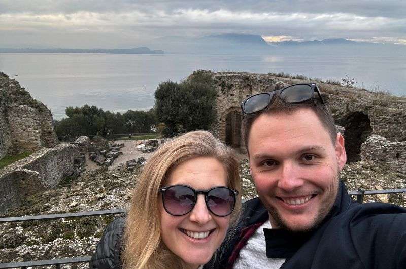 couple in Sirmione, a historic town on Lake Garda's peninsula, Alpine views, Italy, photo by Next level of travel