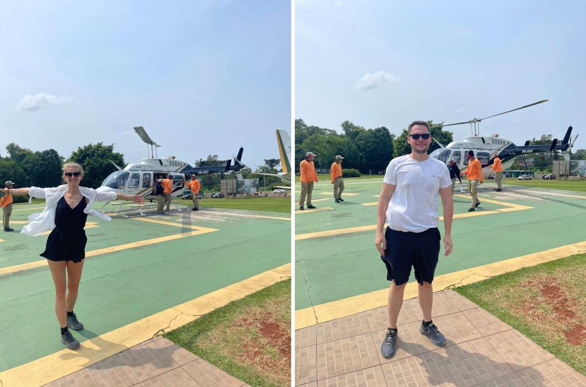 Couple posing separately in front of a helicopter on a landing pad in Argentina; photo by Next Level of Travel