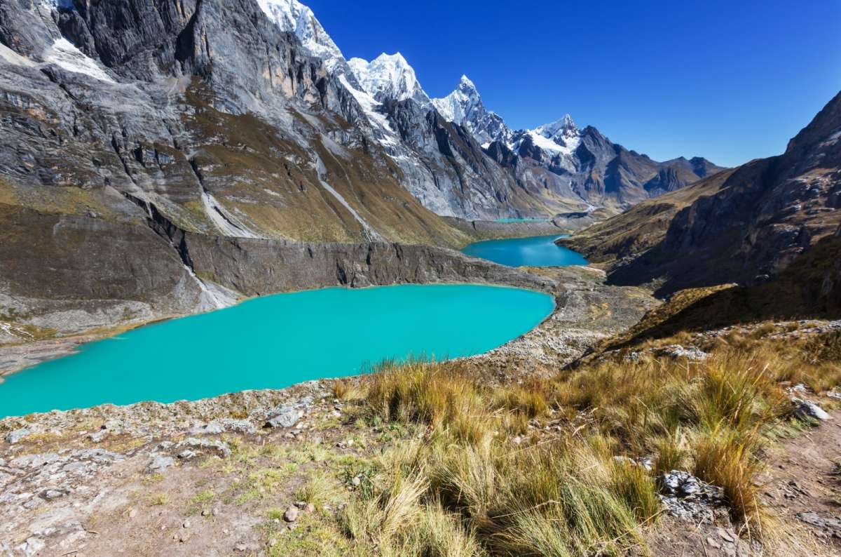 Glacial lakes surrounded by steep mountains and snowy peaks near Laguna de los Tres in Argentina