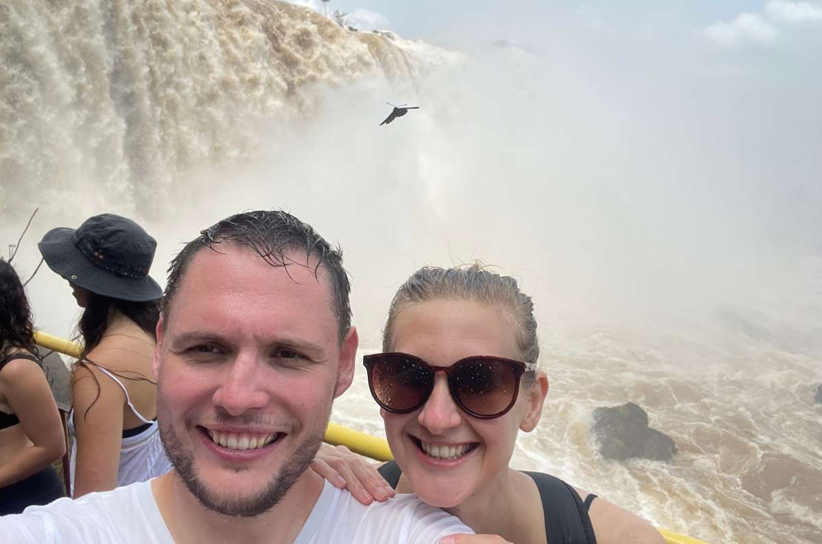 Smiling couple in front of Iguazú Falls, Argentina, photo by Next Level of Travel