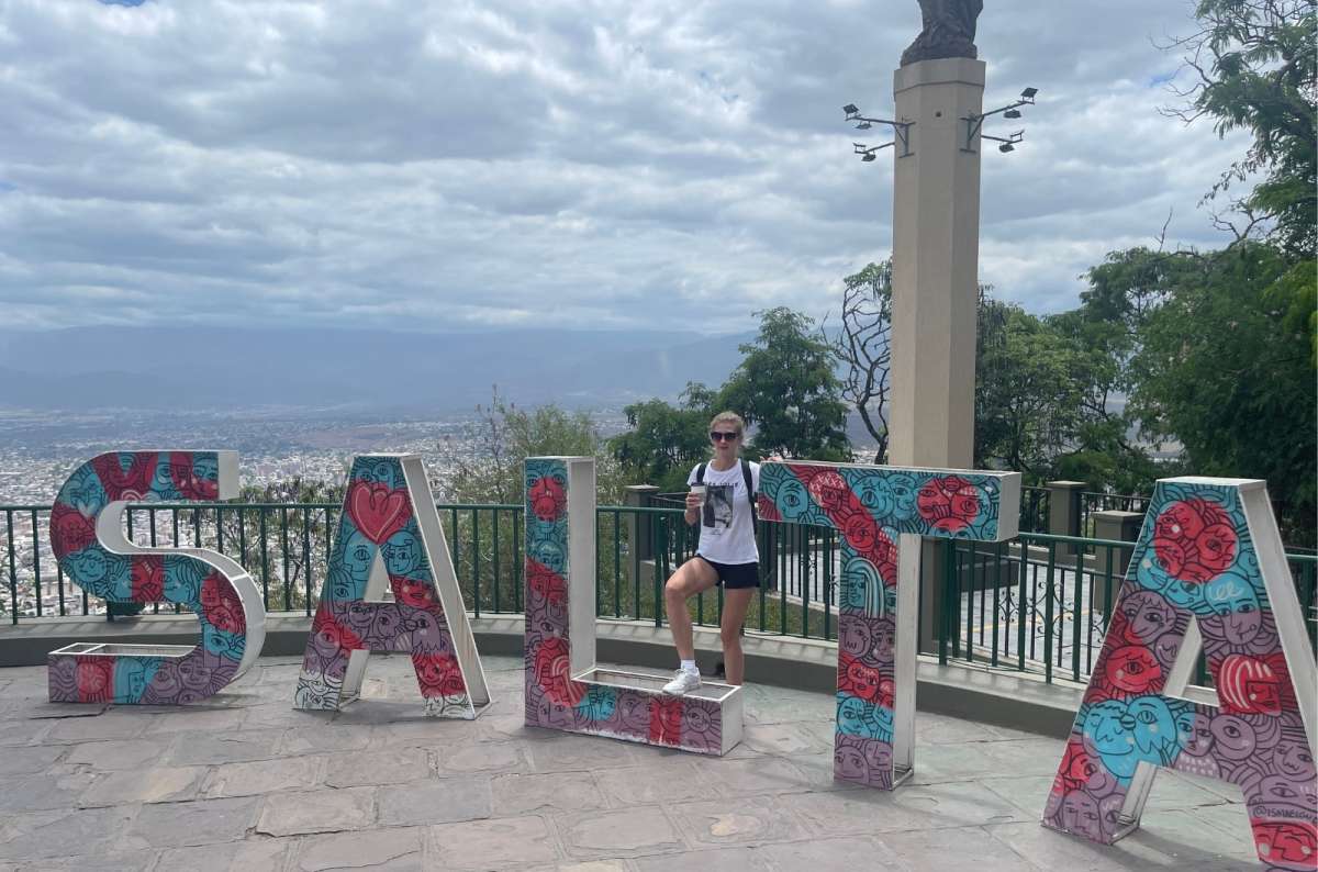 Tourist posing at a viewpoint overlooking the city of Salta, Argentina, photo by Next Level of Travel