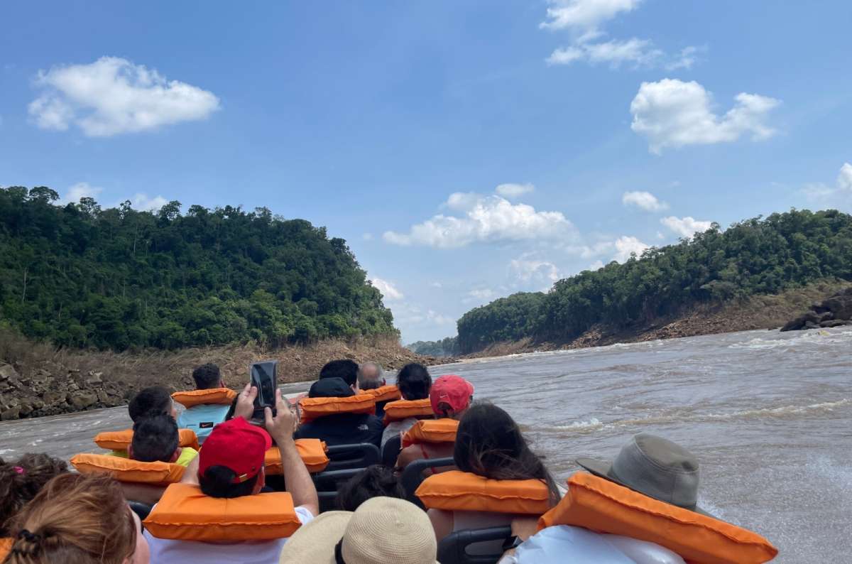 Tourists wearing life jackets on a boat ride through a river canyon in Argentina, photo by Next Level of Travel