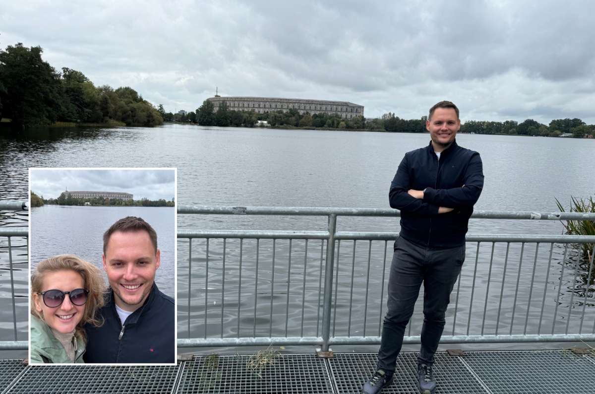 photos of two tourist posing in front of a lake with the Nazi Rally Grounds in the backgrounds, photo by Next Level of Travel