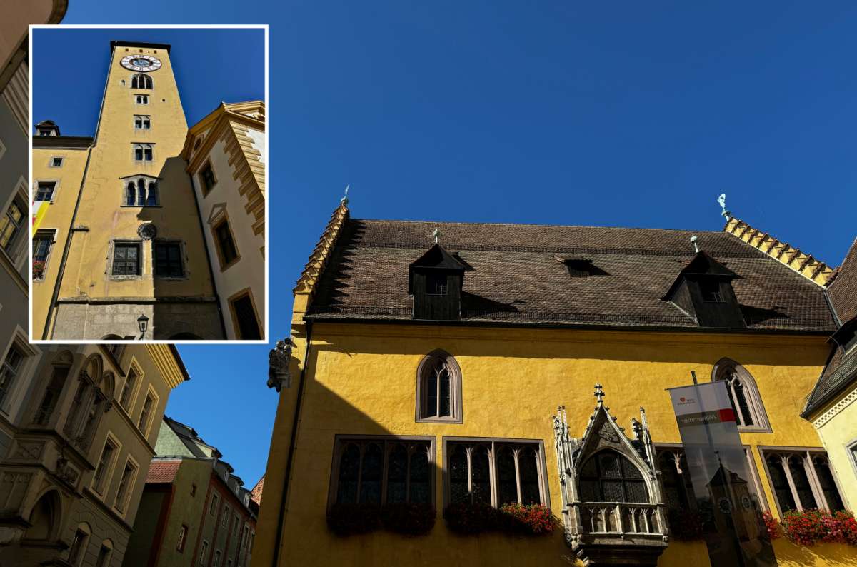 Regensburg’s yellow Altes Rathaus with Gothic windows and balcony, and a woman walking in a nearby Old Town alley, Germany, photo by Next Level of Travel
