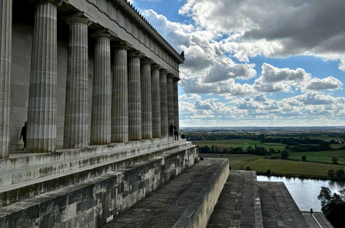 Side view of Walhalla’s massive stone columns overlooking a sweeping landscape and the Danube River, Germany, photo by Next Level of Travel