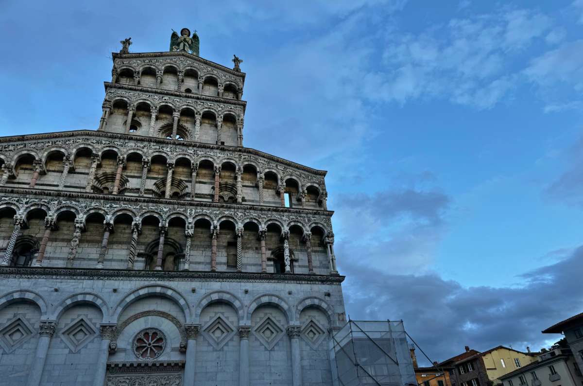San Michele in Foro’s elaborate white marble façade set against a twilight sky, one day in Lucca, Italy travel blog, photo by Next Level of Travel