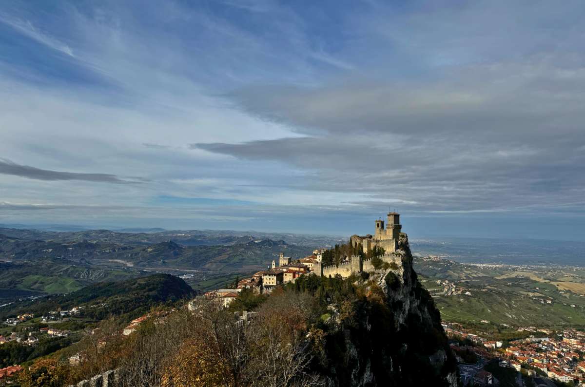 Panoramic view of San Marino's Guaita fortress, Italy, perched on a cliff, photo by Next Level of Travel