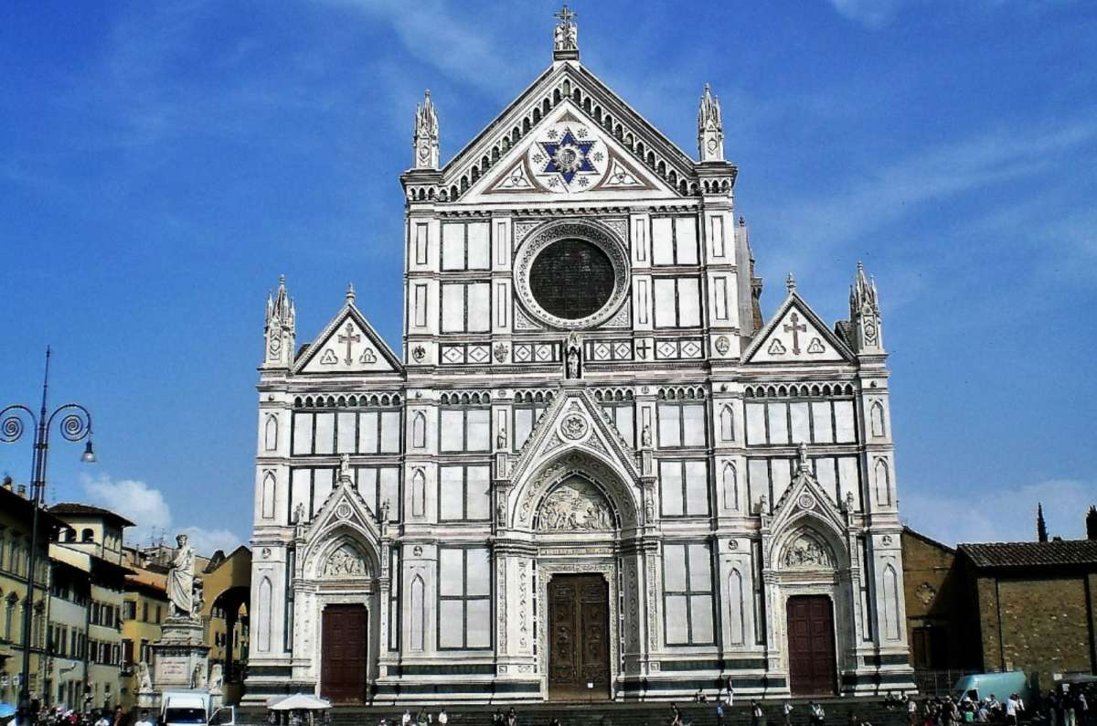 Façade of the Basilica di Santa Croce with its white, green, and pink marble exterior on Piazza di Santa Croce, Florence, Italy