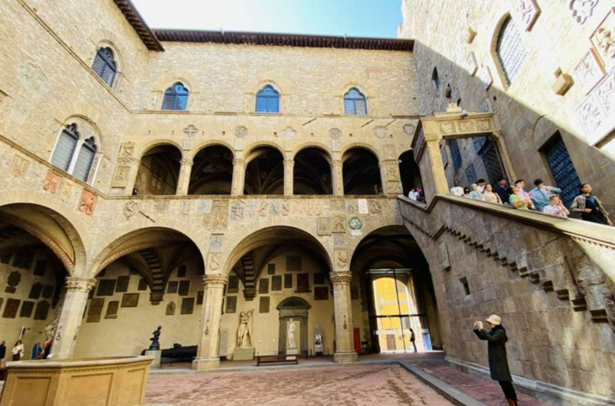 Inner courtyard of the Museo Nazionale del Bargello with arched loggias, medieval sculptures, and central well, Florence, Italy