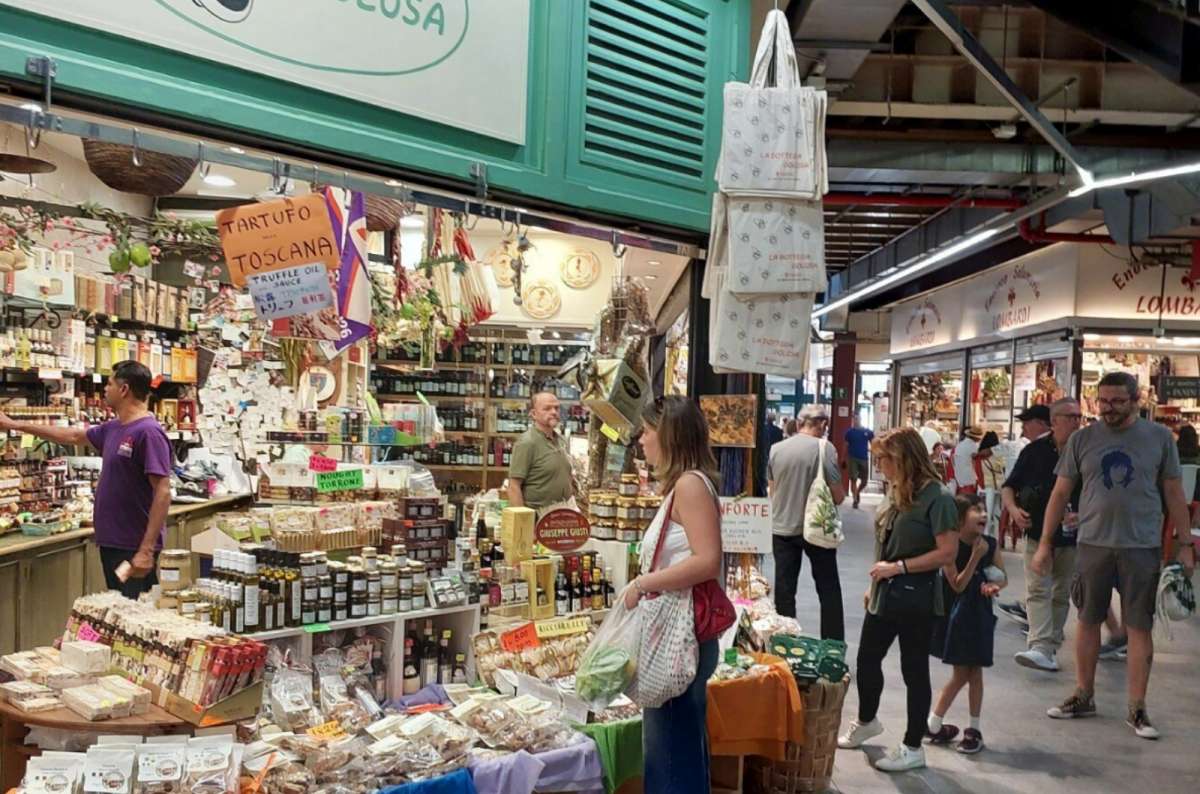 Local food stand at Mercato Centrale in Florence, Italy, with truffle products, pasta, and sweets on display