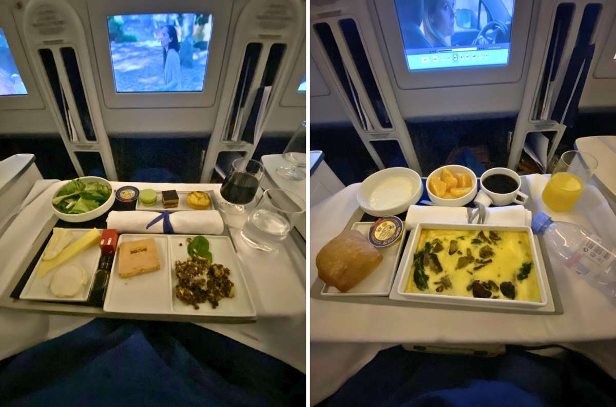 Business class in-flight meals served on real plates with multiple courses, beverages, and elegant presentation on tray tables, photo by Next Level of Travel