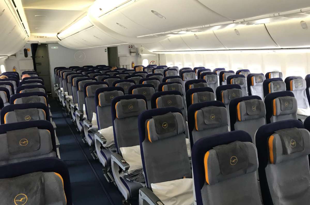 Economy class seating on a Lufthansa aircraft with a 3-4-3 seat layout and minimal legroom, photo by Next Level of Travel