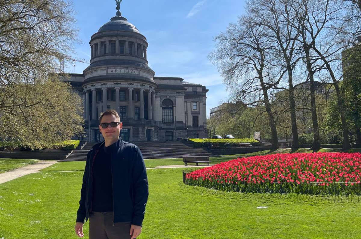 A man standing in front of the Royal Museums of Art and History in Brussels, Belgium, photo by Next Level of Travel