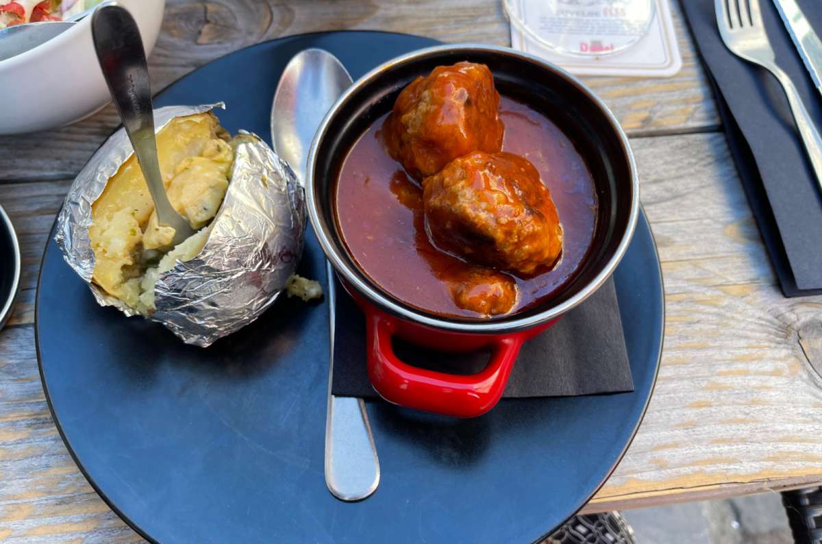 a photo of a traditional Flemish stew served with a baked potato, Ghent, Belgium, photo by Next Level of Travel
