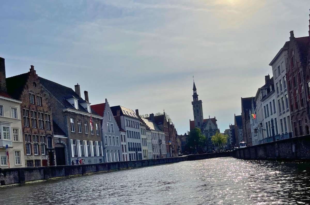 a photo of one of the many Bruges canals in the evening with the sun setting, Bruges, Belgium, photo by Next Level of Travel