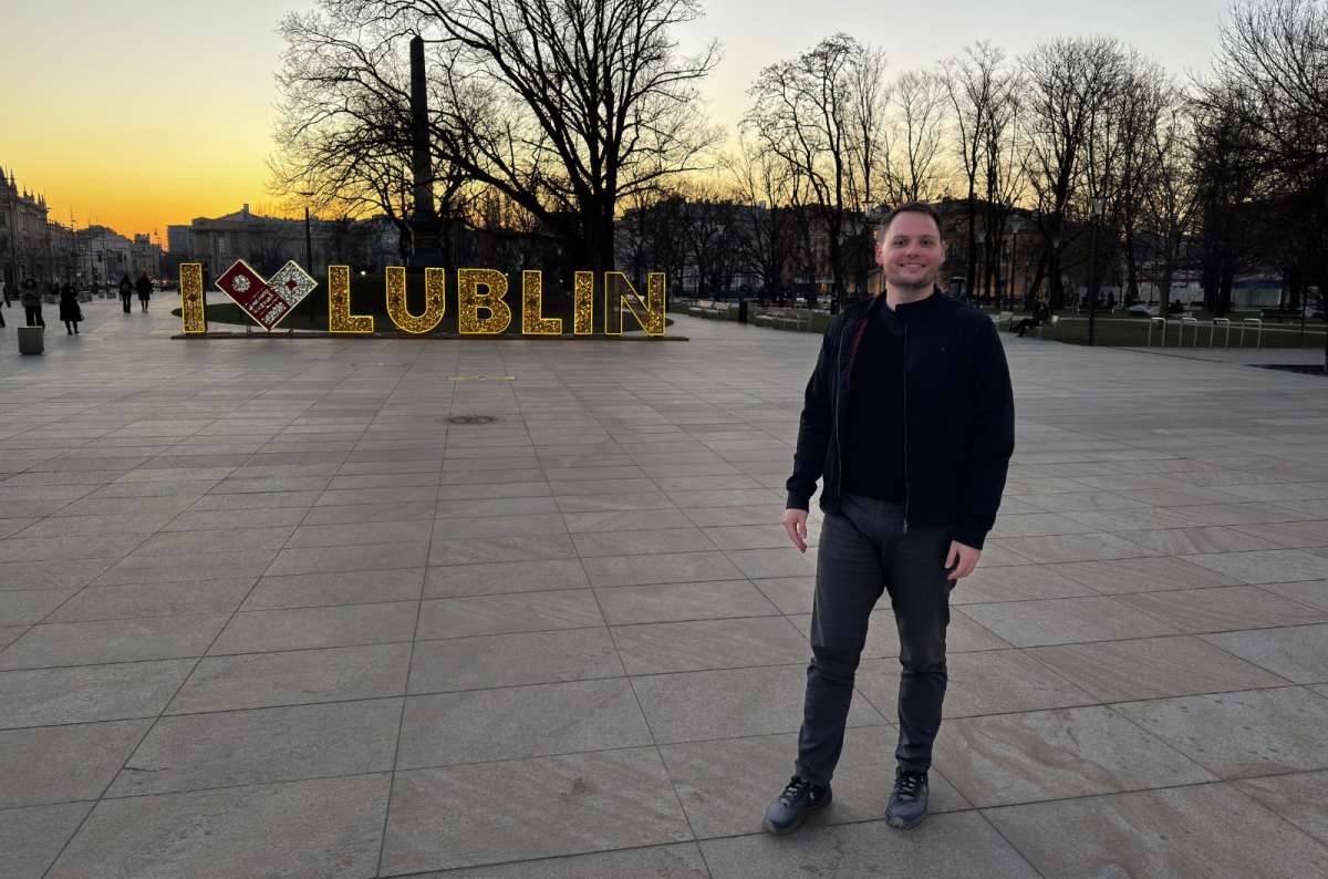  a photo of a tourist posing in front of an LED sign saying “I love Lublin” in Litwwski square, Lublin, Poland, photo by Next Level of Travel
