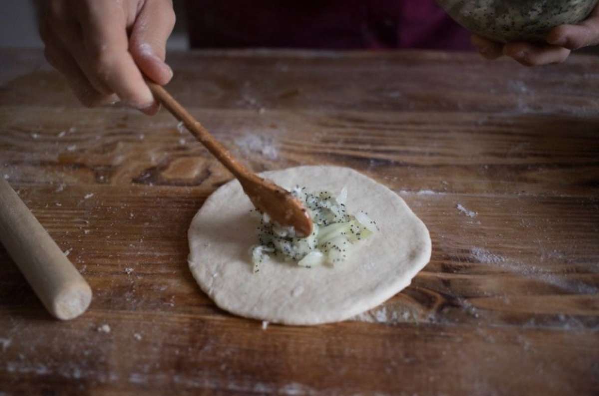 a photo of the preparation of cebularz at the Bread Museum, a traditional Polish meal, Lublin, Poland