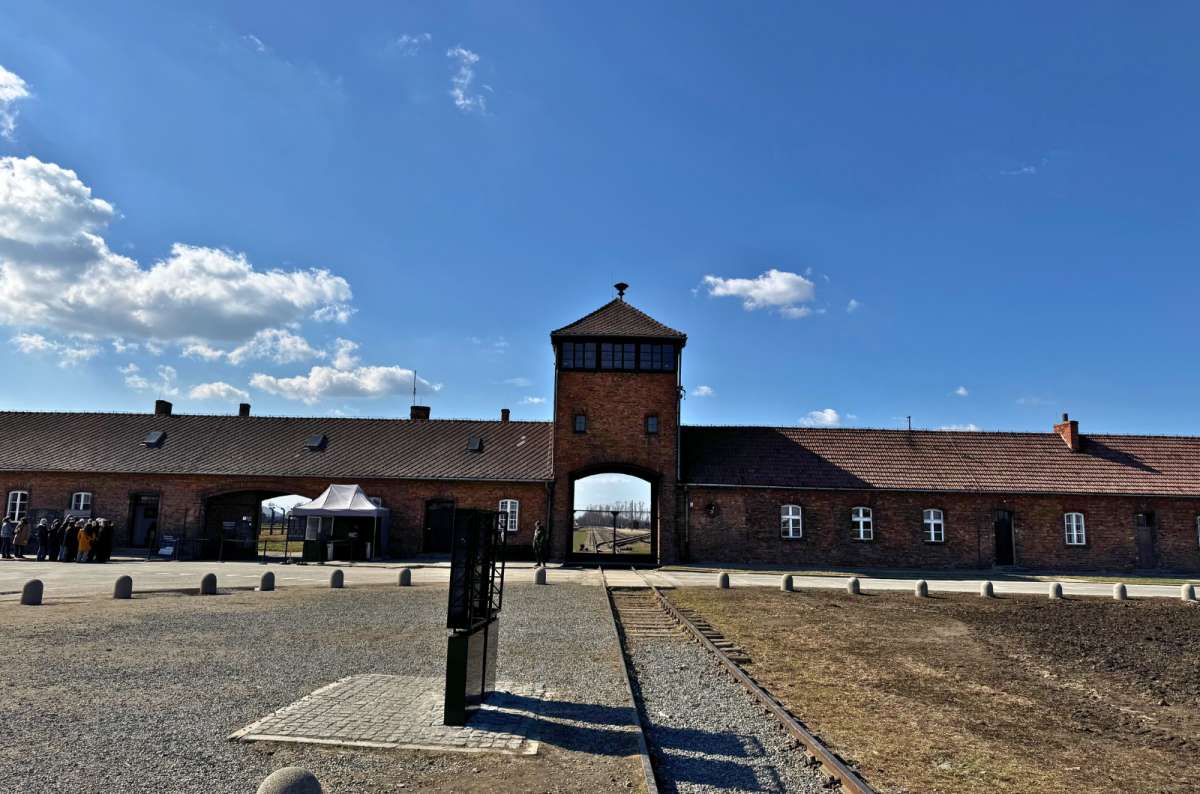 a photo of the main entrance gate to Auschwitz, Poland, photo by Next Level of Travel