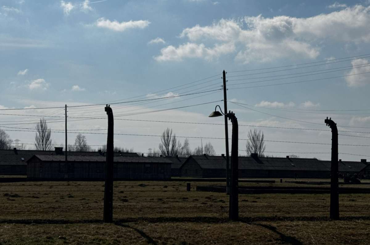 a photo from the Auschwitz concentration camp, showing the barbed wire that surrounds the camp, Oświęcim , Poland, photo by Next Level of Travel