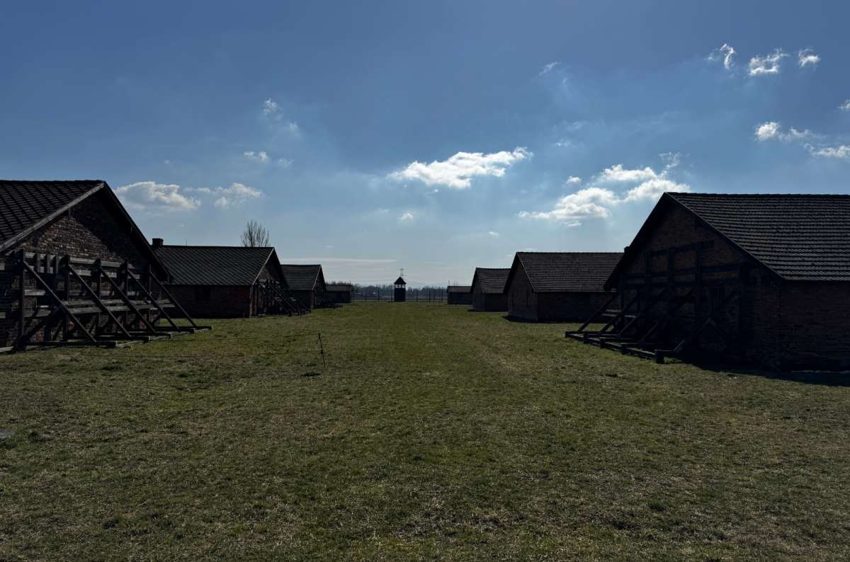 a photo from the outside of the barracks in Auschwitz showing the vast area of the camp, Oświęcim, Poland, Next Level of Travel