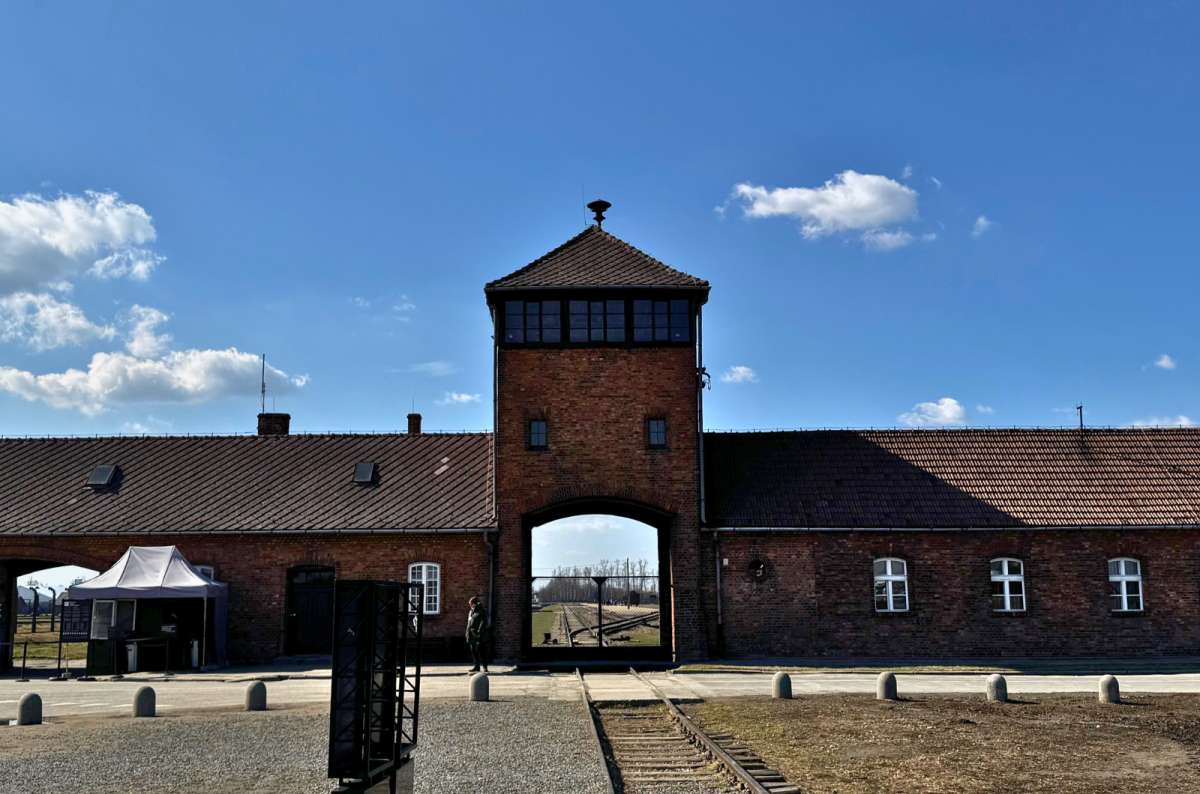 a photo of the main gate that prisoners used to serve to bring in prisoners from all over Europe, Oświęcim, Poland, photo by Next Level of Travel