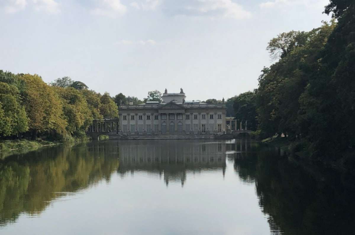 Pałac na Wyspie (Palace on the Isle) reflected in the lake at Łazienki Park in Warsaw, Poland, surrounded by trees and calm water