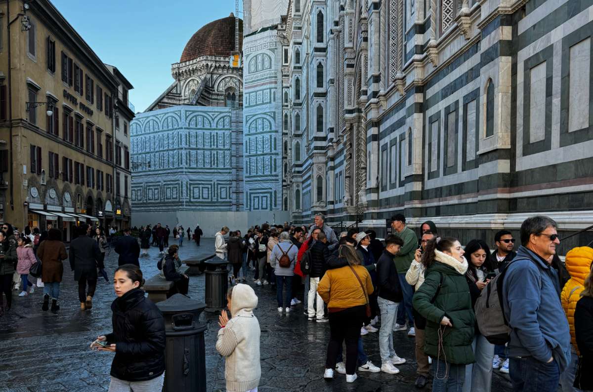 Tourists lining up outside Florence Cathedral (Duomo di Firenze) on Piazza del Duomo in Florence, Italy, with scaffolding and restoration work visible, photo by Next Level of Travel