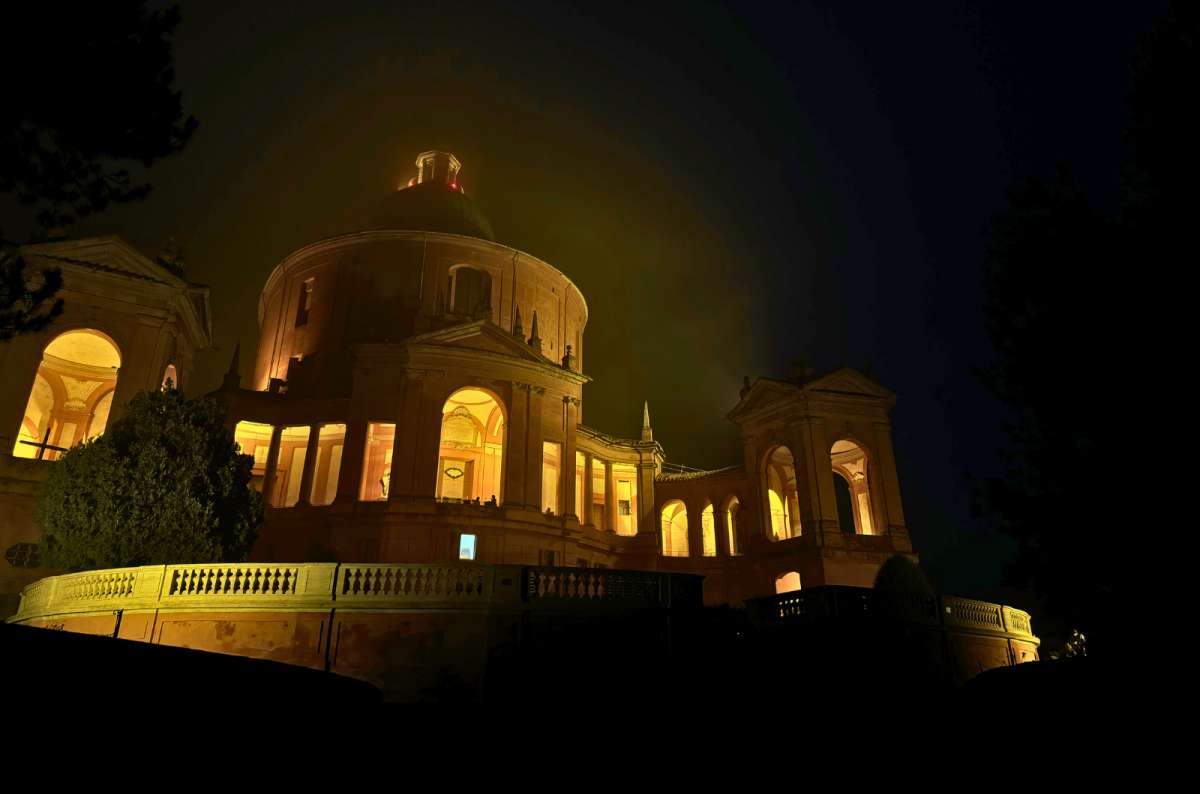 Sanctuary of the Madonna di San Luca illuminated at night in Bologna, Italy, photo by Next Level of Travel
