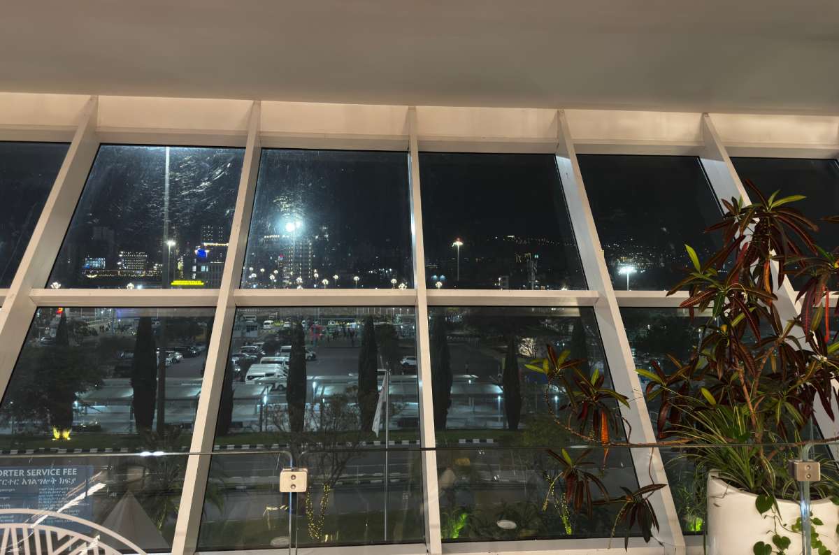 a photo of the dark outdoor area taken from the airport window in Addis Ababa after landing, photo by Next Level of Travel