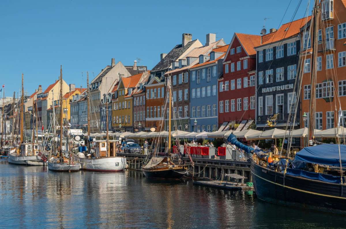 Colorful waterfront houses and boats along Nyhavn canal, Copenhagen, Denmark