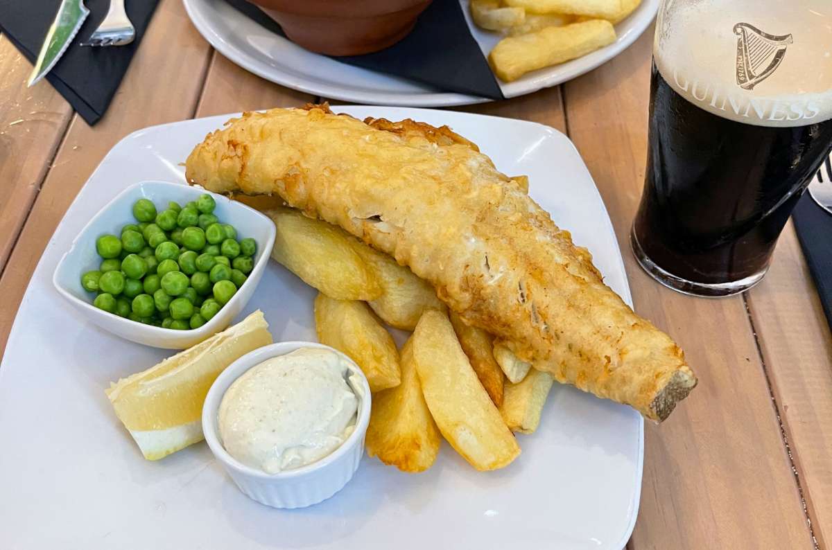 Fish and chips served with potatoes and peas in Gibraltar